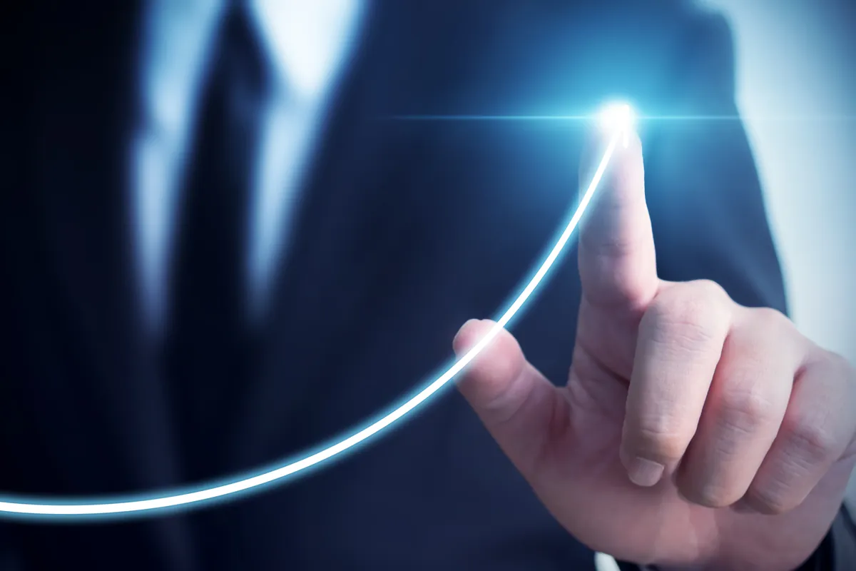 Businessman tracing a rising growth curve, representing SEO traffic and revenue growth